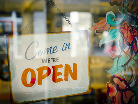 open sign on front door of business