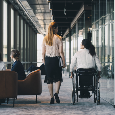 lady in wheelchair, walking with another lady