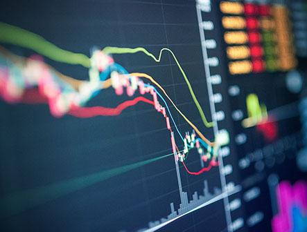 angled shot of computer screen with financial graphs